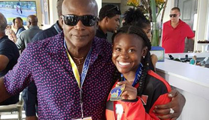 Hasely Crawford, Olympic 100 metres gold medallist, congratulates double gold medalist Khalifa St Fort at the Flow Carifta Games in Curacao, yesterday. Hasely Crawford, Olympic 100 metres gold medallist, congratulates double gold medalist Khalifa St Fort at the Flow Carifta Games in Curacao, yesterday.