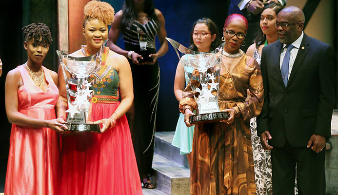 First Citizens Sports Award Winners: Men’s champ Jereem Richards, represented by his sister Brittney (left) holds his trophy along with acting Minister of Sport and Youth Affairs Dr Nyan Gadsby-Dolly (second from right) while Michelle-Lee Ahye, represented by her mother Raquel (second from right) holds her trophy, while chairman of the First Citizens Sports Foundation Dr Keith Clifford (right) looks on. Photo: Azlan Mohammed First Citizens Sports Award Winners: Men’s champ Jereem Richards, represented by his sister Brittney (left) holds his trophy along with acting Minister of Sport and Youth Affairs Dr Nyan Gadsby-Dolly (second from right) while Michelle-Lee Ahye, represented by her mother Raquel (second from right) holds her trophy, while chairman of the First Citizens Sports Foundation Dr Keith Clifford (right) looks on. Photo: Azlan Mohammed
