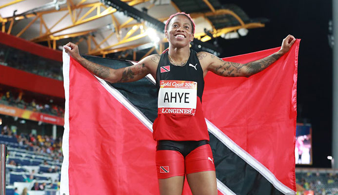 Michelle-Lee Ahye displays the national flag after winning the 100m gold at the Commonwealth Games at Carrara Stadium, Gold Coast, Australia, recently. Michelle-Lee Ahye displays the national flag after winning the 100m gold at the Commonwealth Games at Carrara Stadium, Gold Coast, Australia, recently.