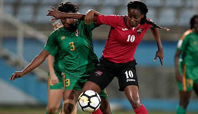 Photo: Trinidad and Tobago captain Tasha St Louis (right) holds off Grenada defender Treasher Valcin during 2019 World Cup qualifying action at the Ato Boldon Stadium on 27 May 2018. (Copyright Annalisa Caruth/Wired868) Photo: Trinidad and Tobago captain Tasha St Louis (right) holds off Grenada defender Treasher Valcin during 2019 World Cup qualifying action at the Ato Boldon Stadium on 27 May 2018. (Copyright Annalisa Caruth/Wired868)