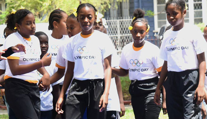 A young gymnast has the attention of other children at Olympic Day 2019 at Lord Harris Square, Port of Spain, on Friday. PHOTOS BY KERWIN PIERRE A young gymnast has the attention of other children at Olympic Day 2019 at Lord Harris Square, Port of Spain, on Friday. PHOTOS BY KERWIN PIERRE