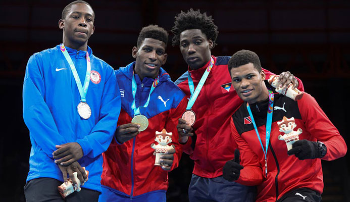 Silver medallist Keyshawn Davis of the United States, left, champion Andy Cruz of Cuba, centre, and bronze medallists Alston Ryan of Antingua and Barbuda, second right, and Michael Alexander of TT in the men's light welterweight boxing at the Pan American Games in Lima, Peru, earlier this month. Silver medallist Keyshawn Davis of the United States, left, champion Andy Cruz of Cuba, centre, and bronze medallists Alston Ryan of Antingua and Barbuda, second right, and Michael Alexander of TT in the men's light welterweight boxing at the Pan American Games in Lima, Peru, earlier this month.