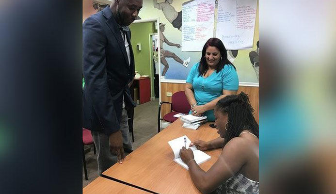 WORDS OF WISDOM: Four-time Olympic medallist Lauryn Williams, right, signs a copy of her book The Oval Office for national football coach Dennis Lawrence as Trinidad and Tobago Olympic Committee executive member Nadine Khan looks on. The book-signing took place at Olympic House on Wednesday. —Photo courtesy: MELANIE GULSTON WORDS OF WISDOM: Four-time Olympic medallist Lauryn Williams, right, signs a copy of her book The Oval Office for national football coach Dennis Lawrence as Trinidad and Tobago Olympic Committee executive member Nadine Khan looks on. The book-signing took place at Olympic House on Wednesday. —Photo courtesy: MELANIE GULSTON