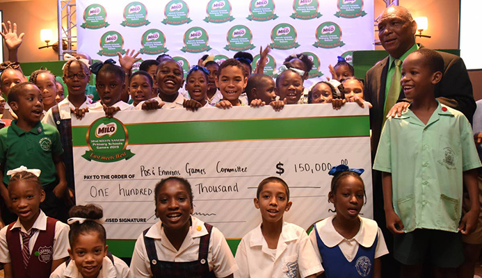 Primary school children display a cheque for $150,000 issued by title sponsor of the 32nd Kelvin Nancoo Games 2019. At right stands chair of the Milo West Games Kelvin Nancoo. Primary school children display a cheque for $150,000 issued by title sponsor of the 32nd Kelvin Nancoo Games 2019. At right stands chair of the Milo West Games Kelvin Nancoo.