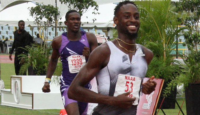 Jereem Richards eases up at the finish -line to win the men’s 200 metres title from the 2018 winner and Abilene Wildcats clubmate Kyle Greaux at the NGC/NAAATT National Open Championships at the Hasely Crawford Stadium, Mucurapo, yesterday. Richards clocked 20-14 seconds and Greaux 2018 with Akanni Hislop of Kaizen Panthers third in 20.68 seconds. Jereem Richards eases up at the finish -line to win the men’s 200 metres title from the 2018 winner and Abilene Wildcats clubmate Kyle Greaux at the NGC/NAAATT National Open Championships at the Hasely Crawford Stadium, Mucurapo, yesterday. Richards clocked 20-14 seconds and Greaux 2018 with Akanni Hislop of Kaizen Panthers third in 20.68 seconds.