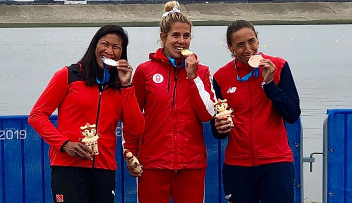 T&T's rower silver medallist Felice Aisha Chow, left, gold medallist Jessica Sevick of Canada, centre, and Chile's Soraya Jadue, the bronze medallist, bite down on their medals after the presentation ceremony for the women's singles sculls at the Pan American Games in Lima Peru on Friday. T&T's rower silver medallist Felice Aisha Chow, left, gold medallist Jessica Sevick of Canada, centre, and Chile's Soraya Jadue, the bronze medallist, bite down on their medals after the presentation ceremony for the women's singles sculls at the Pan American Games in Lima Peru on Friday.