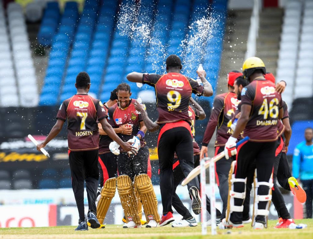Lendl Simmons (2L) and Trinbago Knight Riders team-mates celebrate winning the Hero Caribbean Premier League 2020, at Brian Lara Cricket Academy,Tarouba, on Thursday. - CPL T20 via Getty Images Lendl Simmons (2L) and Trinbago Knight Riders team-mates celebrate winning the Hero Caribbean Premier League 2020, at Brian Lara Cricket Academy,Tarouba, on Thursday. - CPL T20 via Getty Images