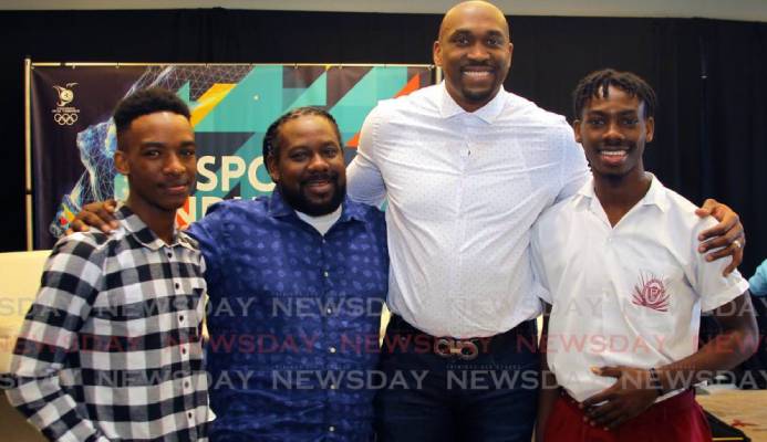Kibwe Trim (second from right), former professional basketballer and founder of DreamChaser International Foundation interacts with brothers Zion Nicholas, left, and Israel Nicholas, right, recipients of the Scholar Athlete of the Year Award 2020 from the DreamChaser International Foundation, alongside their father Kieno Nicholas at the annual TT Olympic Committee Sport Industry Conference 2020, held at the Hyatt Regency, Port of Spain, last Thursday. - ROGER JACOB Kibwe Trim (second from right), former professional basketballer and founder of DreamChaser International Foundation interacts with brothers Zion Nicholas, left, and Israel Nicholas, right, recipients of the Scholar Athlete of the Year Award 2020 from the DreamChaser International Foundation, alongside their father Kieno Nicholas at the annual TT Olympic Committee Sport Industry Conference 2020, held at the Hyatt Regency, Port of Spain, last Thursday. - ROGER JACOB