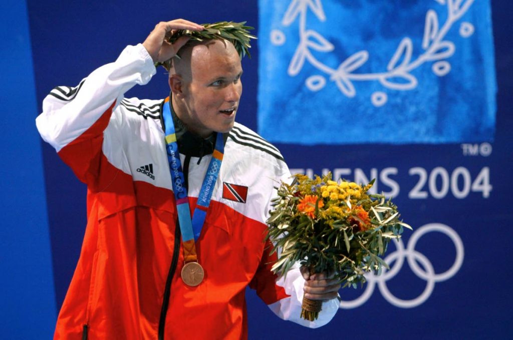 In this August 19, 2004 file photo, TT's George Bovell adjusts his crown after claiming the men's 200m individual medley bronze medal, at the 2004 Olympic Games at the Olympic Aquatic Center in Athens. (AFP PHOTO) - In this August 19, 2004 file photo, TT's George Bovell adjusts his crown after claiming the men's 200m individual medley bronze medal, at the 2004 Olympic Games at the Olympic Aquatic Center in Athens. (AFP PHOTO) -