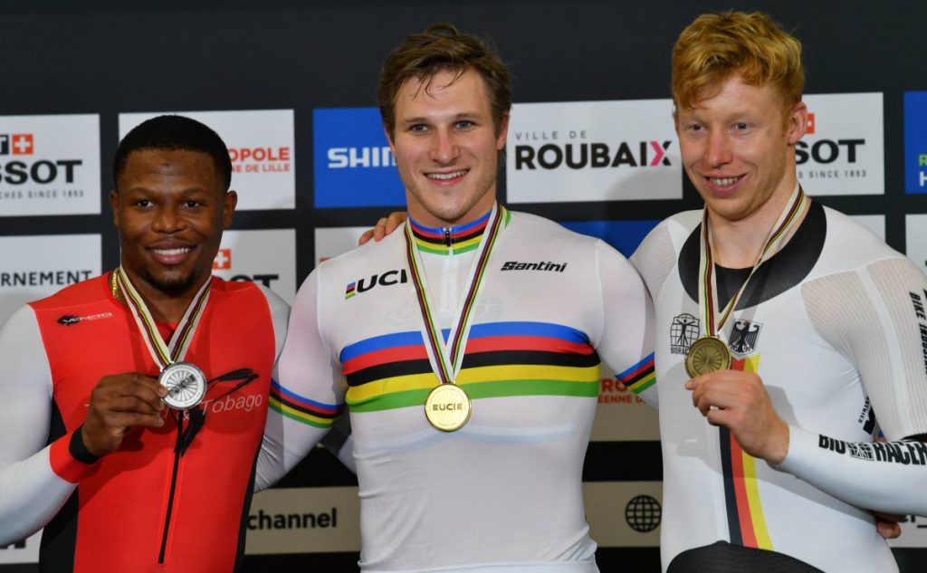 Silver medallist Trinidad and Tobago's Nicholas Paul (left), gold medallist Netherlands' Jeffrey Hoogland (centre) and bronze medallist Germany's Joachim Eilers celebrate on the podium after the men's 1Km Time Trial final during the UCI Track Cycling World Championships at The Jean-Stablinski Velodrome in Roubaix, France, on Friday. (AFP PHOTO) Silver medallist Trinidad and Tobago's Nicholas Paul (left), gold medallist Netherlands' Jeffrey Hoogland (centre) and bronze medallist Germany's Joachim Eilers celebrate on the podium after the men's 1Km Time Trial final during the UCI Track Cycling World Championships at The Jean-Stablinski Velodrome in Roubaix, France, on Friday. (AFP PHOTO)