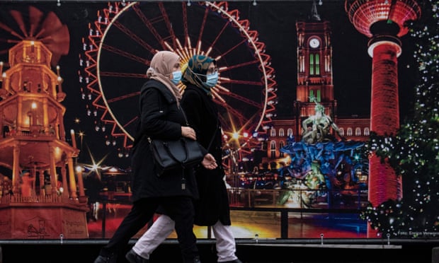 Women wearing face masks walk past the site of a traditional Christmas market in Berlin. The global study found that mask wearing was the most effective way to curb Covid infections. Photograph: John MacDougall/AFP/Getty Images Women wearing face masks walk past the site of a traditional Christmas market in Berlin. The global study found that mask wearing was the most effective way to curb Covid infections. Photograph: John MacDougall/AFP/Getty Images