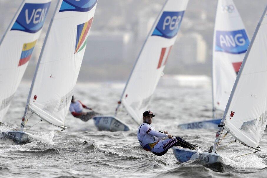 SMOOTH SAILING: T&T’s Andrew Lewis, right, competes during the Laser men’s event at the 2016 Summer Olympics in Rio de Janeiro, Brazil. —Photos: AP SMOOTH SAILING: T&T’s Andrew Lewis, right, competes during the Laser men’s event at the 2016 Summer Olympics in Rio de Janeiro, Brazil. —Photos: AP