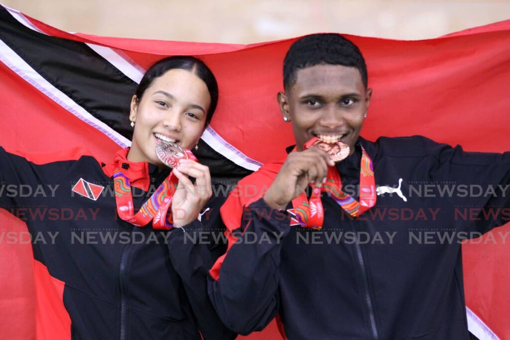 Makaira Wallace, left, and Syndel Samaroo with their Commonwealth Youth Games cycling medals at the National Cycling Velodrome, Couva, Thursday. - Lincoln Holder (Image obtained at newsday.co.tt) Makaira Wallace, left, and Syndel Samaroo with their Commonwealth Youth Games cycling medals at the National Cycling Velodrome, Couva, Thursday. - Lincoln Holder (Image obtained at newsday.co.tt)