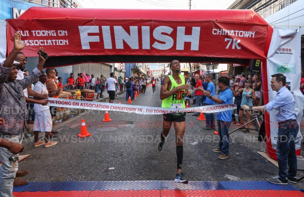 Nicholas Romany crosses the finish line to win the Chinatown 7K on Charlotte Street, Port of Spain on Sunday. - Photo by Jeff K Mayers (Image obtained at newsday.co.tt) Nicholas Romany crosses the finish line to win the Chinatown 7K on Charlotte Street, Port of Spain on Sunday. - Photo by Jeff K Mayers (Image obtained at newsday.co.tt)