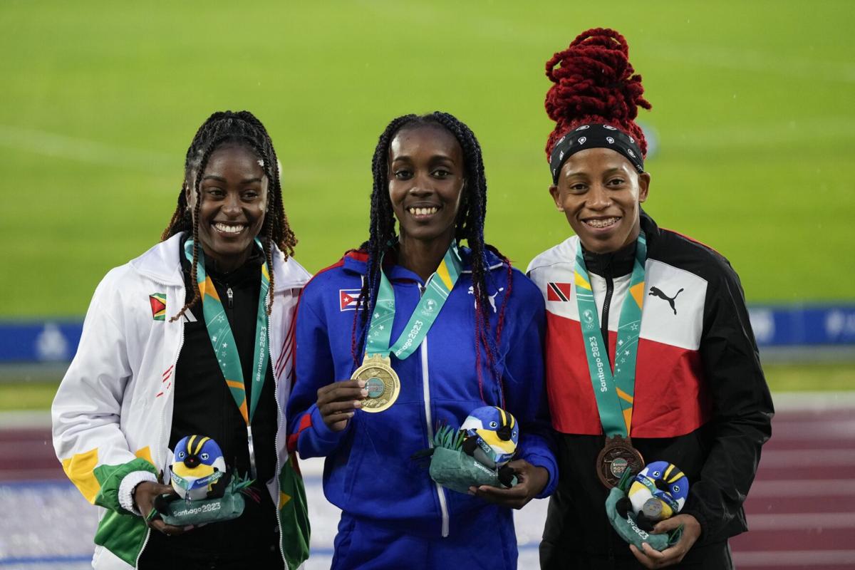 PODIUM PRIDE: Women’s 100-metre medallists, from left, Guyana’s Jasmine Abrams, silver, Cuba’s Yunisleidy Garcia, gold, and Trinidad and Tobago’s Michelle-Lee Ahye, bronze, pose on the podium at the Pan American Games in Santiago, Chile, yesterday. —Photo: AP  Silvia Izquierdo (Image obtained at trinidadexpress.com) PODIUM PRIDE: Women’s 100-metre medallists, from left, Guyana’s Jasmine Abrams, silver, Cuba’s Yunisleidy Garcia, gold, and Trinidad and Tobago’s Michelle-Lee Ahye, bronze, pose on the podium at the Pan American Games in Santiago, Chile, yesterday. —Photo: AP  Silvia Izquierdo (Image obtained at trinidadexpress.com)