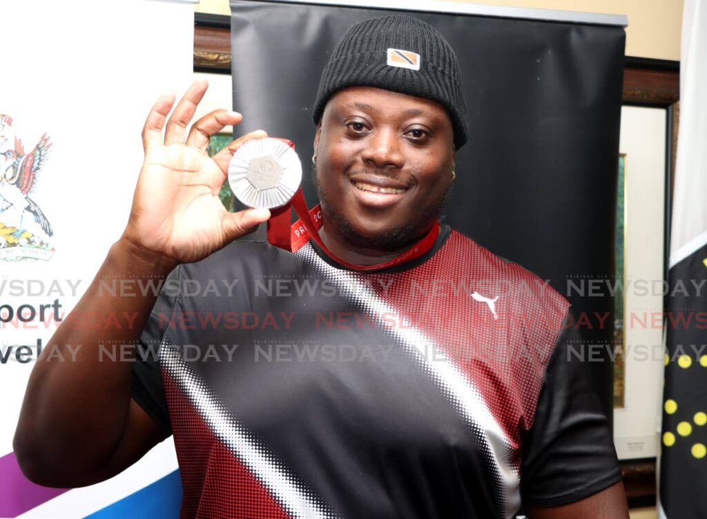 Paralympic Games men’s discuss F64 silver medallist Akeem Stewart shows off his medal after his return to Piarco International Airport, Piarco on September 10. (Image obtained at newsday.co.tt) Paralympic Games men’s discuss F64 silver medallist Akeem Stewart shows off his medal after his return to Piarco International Airport, Piarco on September 10. (Image obtained at newsday.co.tt)