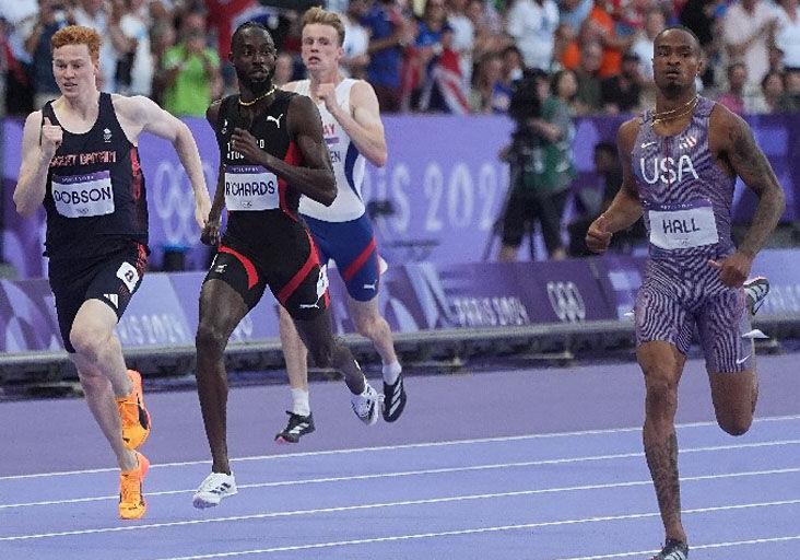 PODIUM PURSUIT: Jereem “The Dream” Richards, second from left, en route to a second-place finish in the opening Olympic Games men’s 400 metres semi-final heat at the Stade France, in Paris, yesterday. Richards clocked 44.33 seconds to finish behind American Quincy Hall, right, the winner in 43.95. Briton Charlie Dobson, left, and Norway’s Havard Ingvaldsen, second from right, were fourth and seventh, respectively, clocking 44.48 and 45.60. Richards and Hall will run in today’s final.   —Photo: BRENT STUBBS (Image obtained at trinidadexpress.com) PODIUM PURSUIT: Jereem “The Dream” Richards, second from left, en route to a second-place finish in the opening Olympic Games men’s 400 metres semi-final heat at the Stade France, in Paris, yesterday. Richards clocked 44.33 seconds to finish behind American Quincy Hall, right, the winner in 43.95. Briton Charlie Dobson, left, and Norway’s Havard Ingvaldsen, second from right, were fourth and seventh, respectively, clocking 44.48 and 45.60. Richards and Hall will run in today’s final.   —Photo: BRENT STUBBS (Image obtained at trinidadexpress.com)