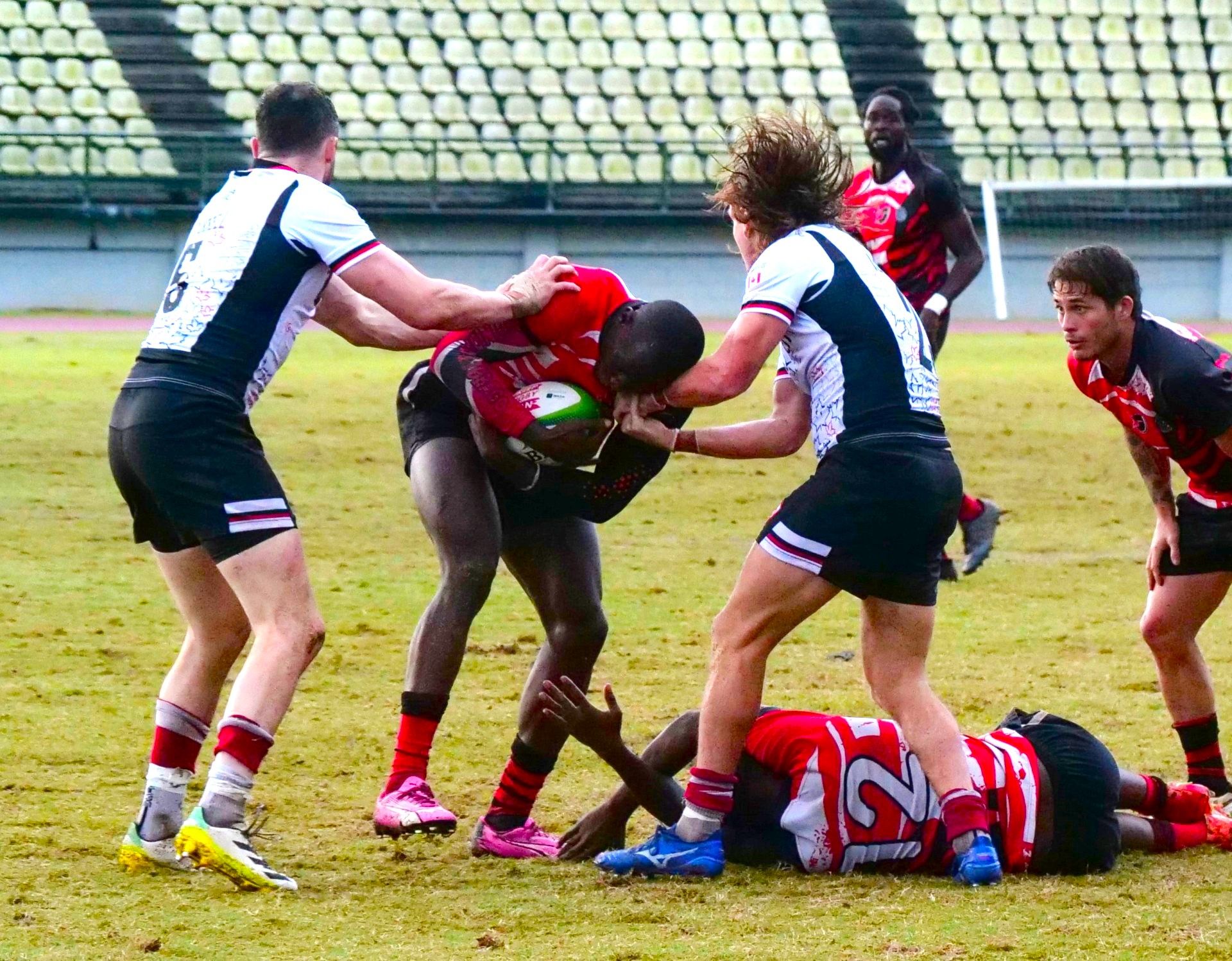 T&T captain Shakeel Dyte attempts to push through the Canada defensive line, Alex Russell and Thomas Isherwood during the men’s final in the RAN Sevens Tournament at Larry Gomes Stadium in Malabar, Arima, yesterday. T&T suffered a 38-0 loss.  ROGER JACOB (Image obtained at guardian.co.tt) T&T captain Shakeel Dyte attempts to push through the Canada defensive line, Alex Russell and Thomas Isherwood during the men’s final in the RAN Sevens Tournament at Larry Gomes Stadium in Malabar, Arima, yesterday. T&T suffered a 38-0 loss.  ROGER JACOB (Image obtained at guardian.co.tt)