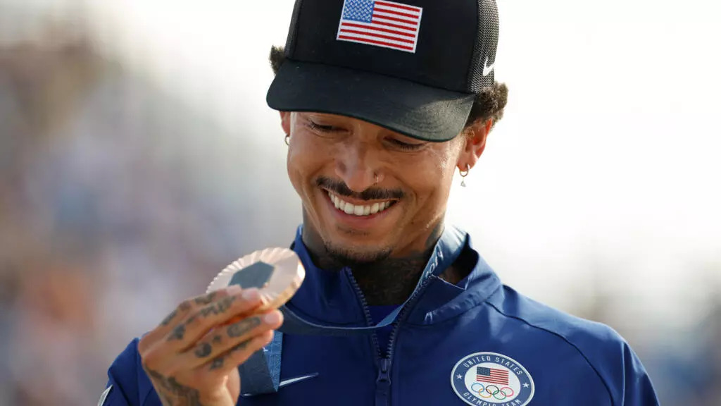 Nyjah Huston holds his bronze medal after the victory ceremony for the men's street skateboarding event on July 29, 2024. © Odd Anderson, AFP (Image obtained at france24.com) Nyjah Huston holds his bronze medal after the victory ceremony for the men's street skateboarding event on July 29, 2024. © Odd Anderson, AFP (Image obtained at france24.com)