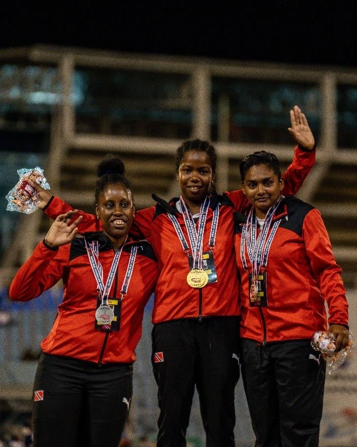 (L-R) TT Special Olympic athletes La Toya Charles (2nd place), Tershana Tempro (1st place) and Melissa Nanan (3rd) celebrate on the podium after competing in the girls' 200m dash Special Olympics Open, during the 52nd Carifta Games, at the Hasely Crawford Stadium, Port of Spain. - Photo by Rondell Paul (Image obtained at newsday.co.tt)