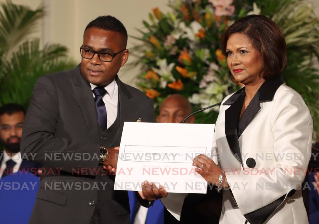 Minister of Sport and Youth Affairs Phillip Watts receives his instruments of appointment from President Christine Kangaloo at President's House, St Ann's, May 3. - Photo by Angelo Marcelle (Image obtained at newsday.co.tt)