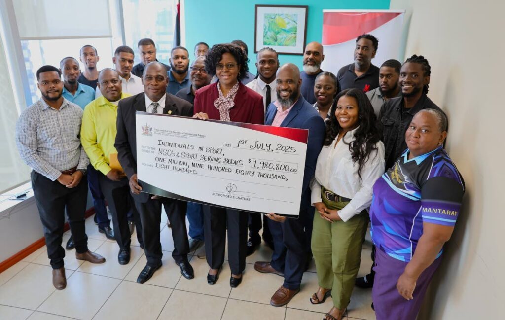 Permanent secretary of the Ministry of Sport and Youth Affairs Beverly Reid-Samuel, middle, with a cheque for sporting organisations and athletes at the Ministry of Sports and Youth Affairs head office in Port of Spain. - Photo courtesy the MSYA Facebook page (Image obtained at newsday.co.tt)