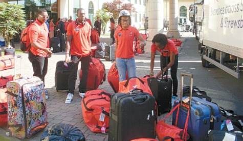T&T Olympic track athletes from left: 110m hurdler Wayne Davis II, reigning national 200m champion, Rondel Sorillo, 100m sprinter Michelle-Lee Ahye and 100m sprinter Sparkle McKnight sort out their luggage after arriving at the Games Village yesterday. Chef de mission, Annette Knox stated the team had settled in nicely at the Village following its pre-Olympic camp in Wales. Photo courtesy TTOC