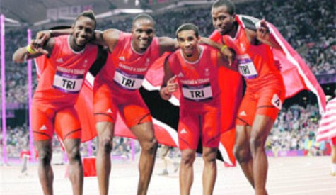 well done: Members of Trinidad and Tobago's men's 4x400m relay team, from left, Ade Alleyne-Forte, Lalonde Gordon, Jarrin Solomon and Deon Lendore, celebrate their bronze medal following yesterday's relay final at the Olympic Stadium in London, England. —Photo: AP