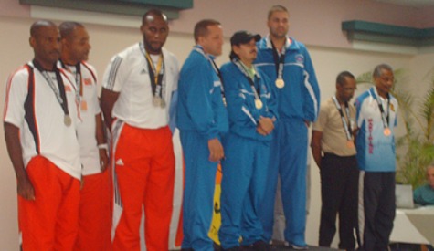 From left Clement Marshall, Rhodney Allen and Roger Daniel stand on the podium after placing second in the men’s 25m standard pistol team event. Hosts Puerto Rico placed first while Martinique placed third.