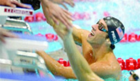 historic moment: US swimmer Michael Phelps, right, celebrates after winning gold in the men's 4x200 metre freestyle relay final at the Aquatics Centre in Olympic Park yesterday, during the 2012 Summer Olympics in London. —Photo: AP